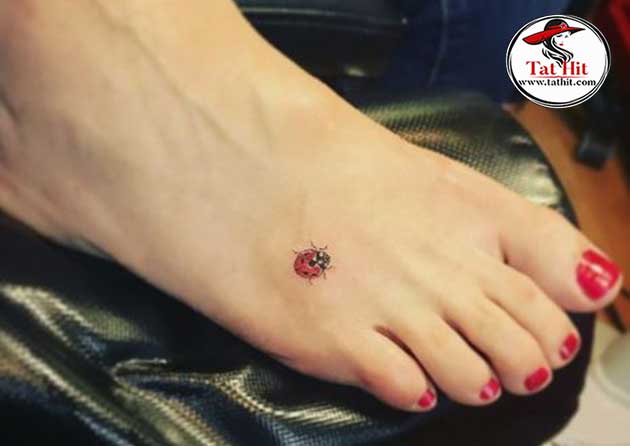 small ladybug tattoo on foot